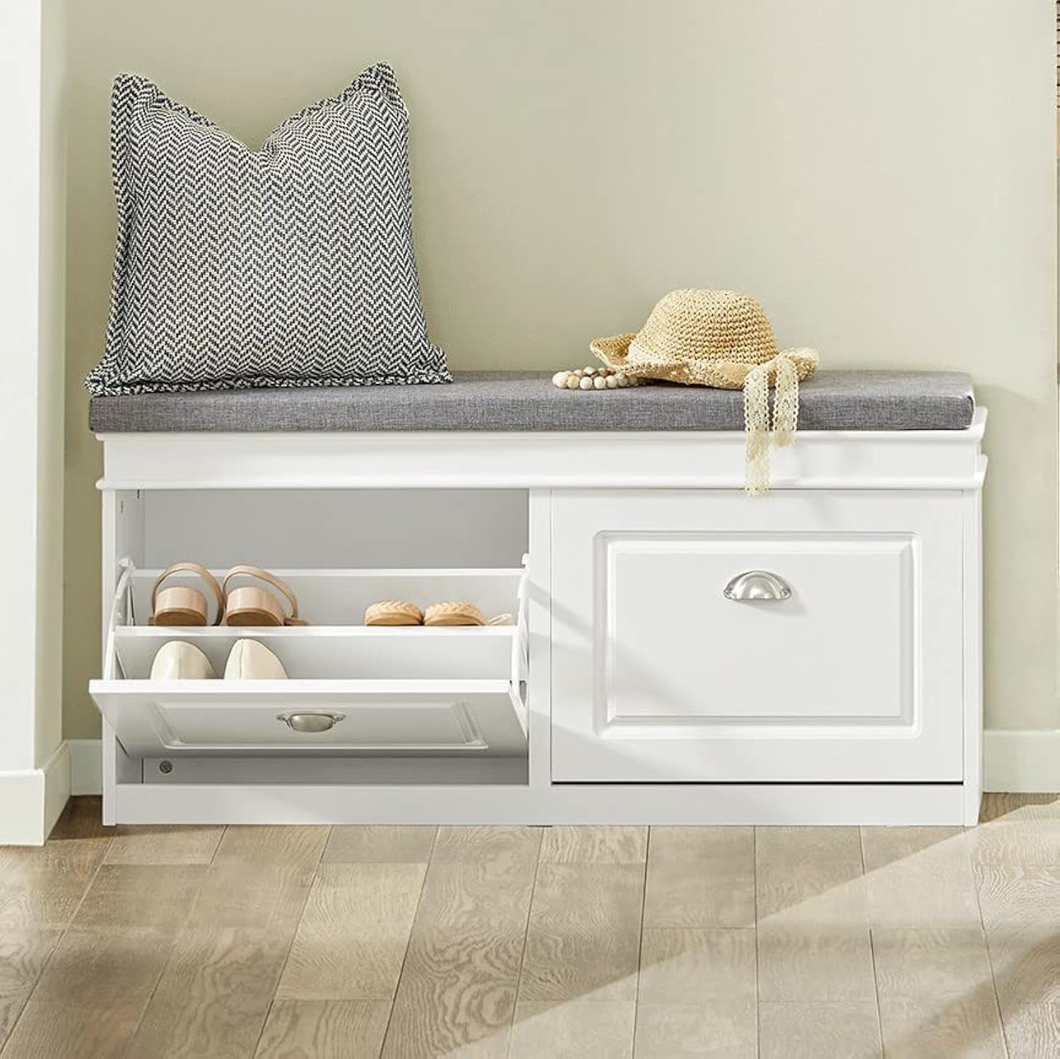 a shoe storage bench with a pillow and hat